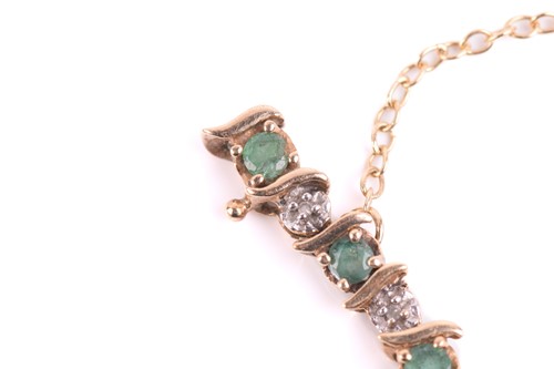 Lot 50 - An emerald and diamond line bracelet in 9ct...