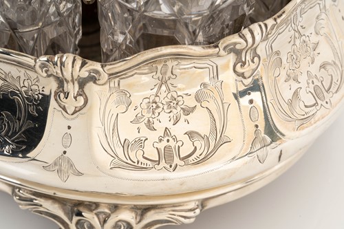 Lot 536 - A Victorian silver seven-bottle table cruet,...
