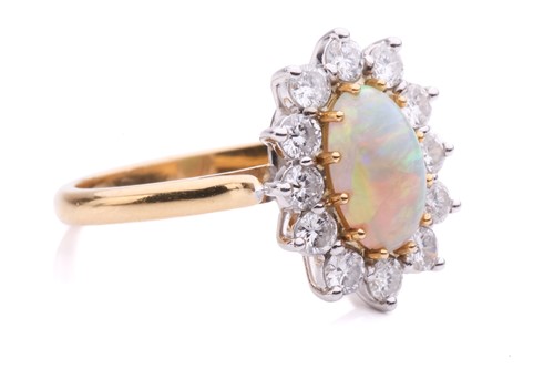 Lot 38 - An opal and diamond entourage ring in 18ct...