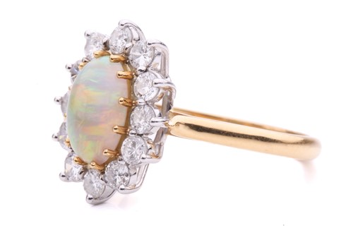 Lot 38 - An opal and diamond entourage ring in 18ct...