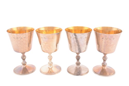 Lot 453 - A set of four matched silver wine goblets,...