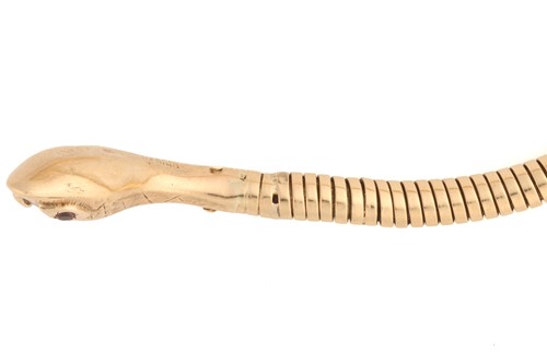 Lot 89 - A 9 carat gold coiled snake bracelet; the gold...