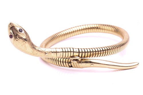 Lot 89 - A 9 carat gold coiled snake bracelet; the gold...