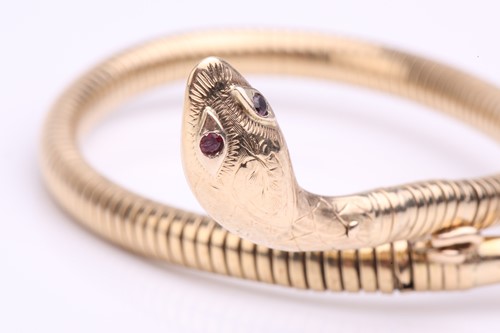 Lot 89 - A 9 carat gold coiled snake bracelet; the gold...