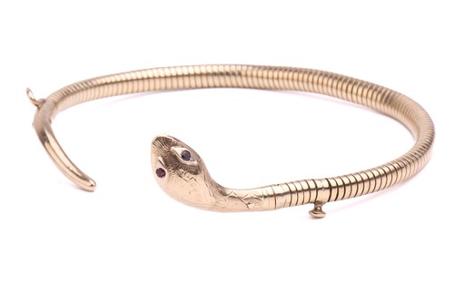Lot 89 - A 9 carat gold coiled snake bracelet; the gold...