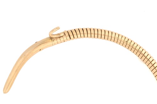 Lot 89 - A 9 carat gold coiled snake bracelet; the gold...