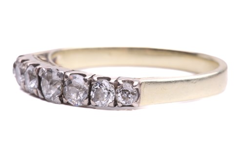 Lot 14 - A seven stone half hoop ring; the slightly...