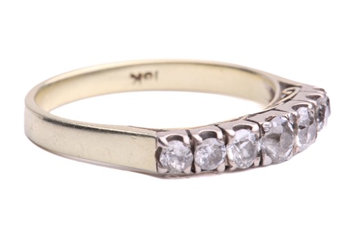 Lot 14 - A seven stone half hoop ring; the slightly...