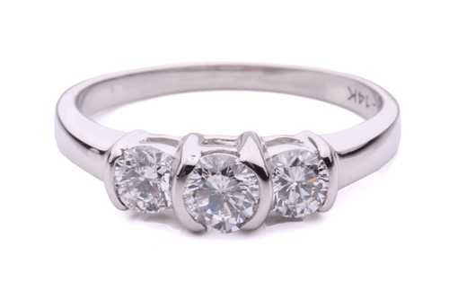 Lot 282 - A three stone half hoop brilliant cut diamond...