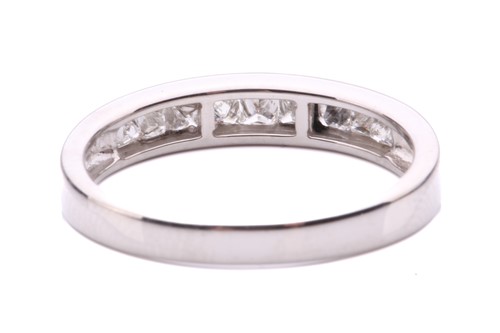 Lot 251 - A diamond half hoop eternity ring, channel set...