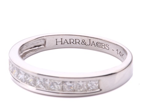 Lot 251 - A diamond half hoop eternity ring, channel set...