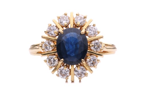 Lot 75 - A sapphire and diamond cluster ring, the oval...