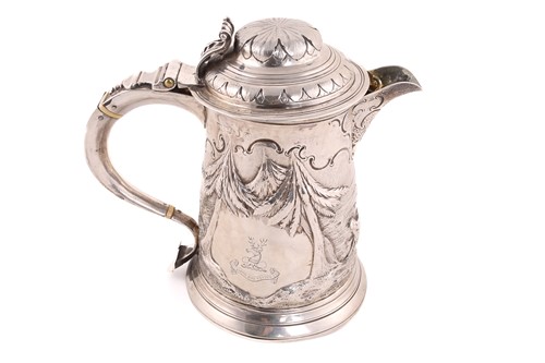 Lot 529 - A George III and later silver jug, the hinged...