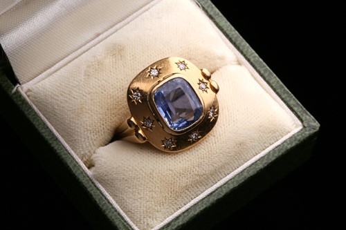 Lot 199 - A sapphire and diamond dress ring, centred...