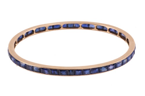 Lot 140 - A French sapphire-set closed bangle,...