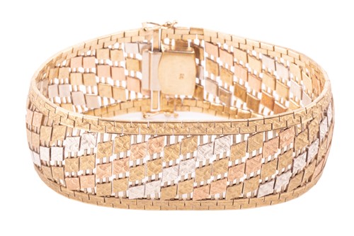 Lot 99 - A 9ct three-tone gold wide brick link bracelet,...