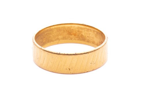 Lot 19 - A wedding band in 22ct yellow gold, with a...