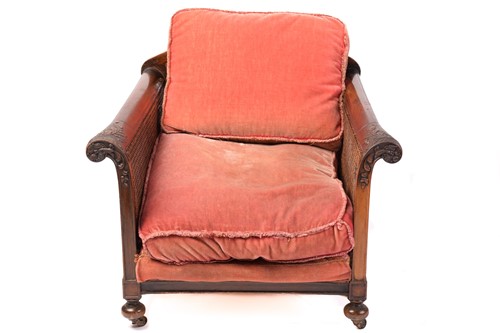 Lot 217 - A carved walnut three-seat Bergere sofa and...