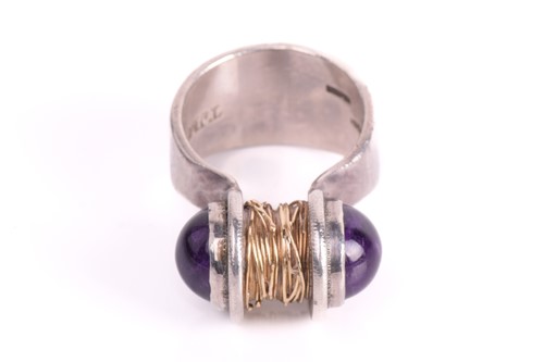 Lot 241 - A Modernist amethyst dress ring, centred with...