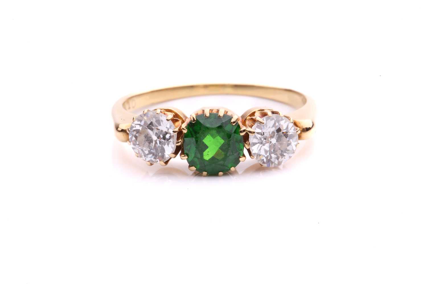 Lot 26 - A tsavorite and diamond three-stone ring,...