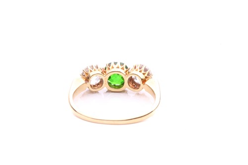 Lot 26 - A tsavorite and diamond three-stone ring,...