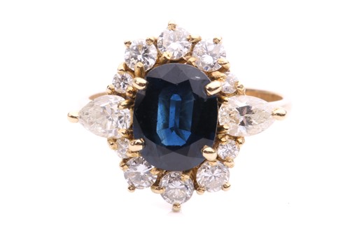 Lot 237 - A sapphire and diamond cluster ring, centred...