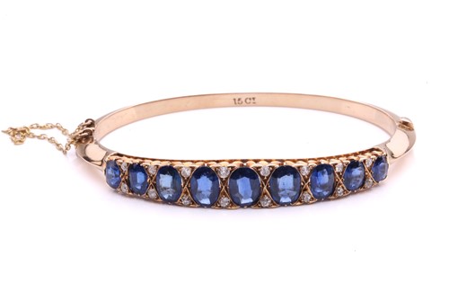 Lot 150 - A sapphire and diamond hinged bangle, the...