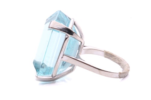 Lot 5 - A large aquamarine solitaire ring, claw-set...