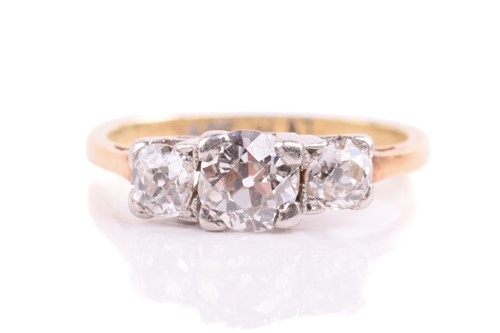 Lot 64 - A three stone half hoop ring; the graduated...