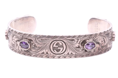 Lot 100 - Gucci - a silver cuff bracelet set with purple...