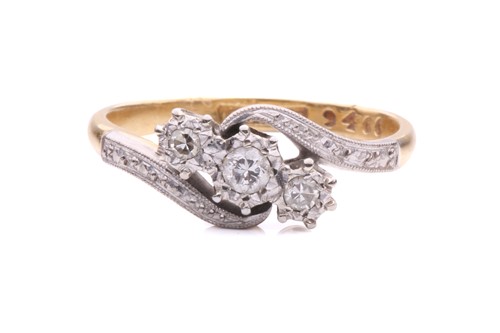 Lot 230 - A three-stone diamond crossover ring, with a...