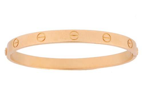 Lot 199 - Cartier - a 'LOVE' bangle, composed of two...