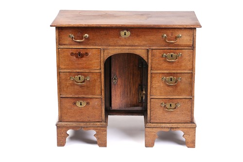 Lot 319 - An 18th-century oak kneehole writing desk...