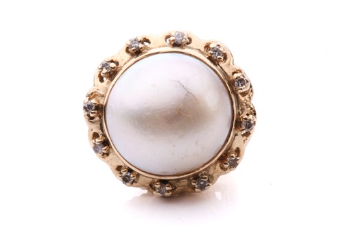 Lot 228 - A pearl and diamond ring set with a central...