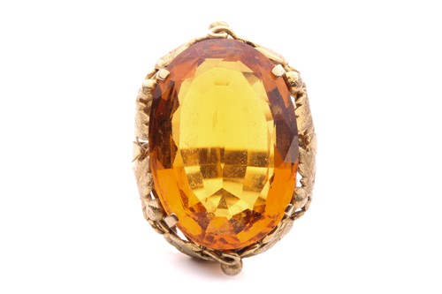 Lot 20 - A citrine solitaire ring set with a large oval-...