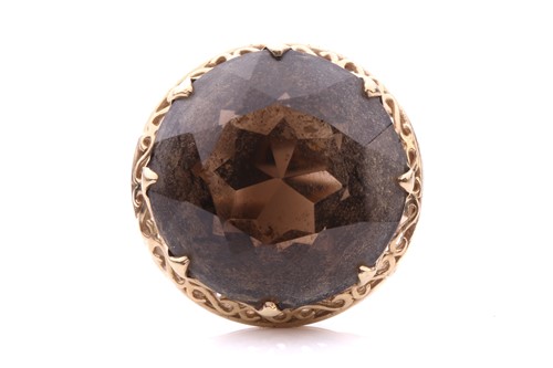 Lot 99 - A solitaire smokey quartz ring featuring a...