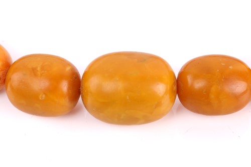 Lot 145 - An amber bead necklace, the opaque amber beads...