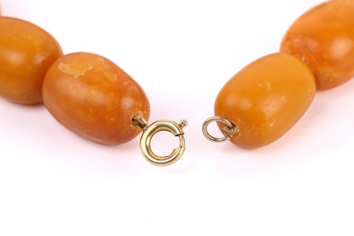 Lot 145 - An amber bead necklace, the opaque amber beads...