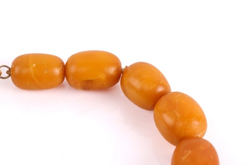 Lot 145 - An amber bead necklace, the opaque amber beads...