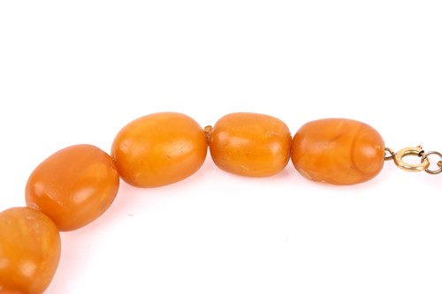 Lot 145 - An amber bead necklace, the opaque amber beads...