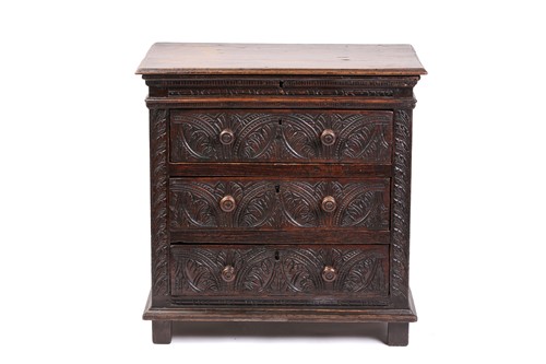 Lot 316 - A carved oak 17th-century style three-drawer...