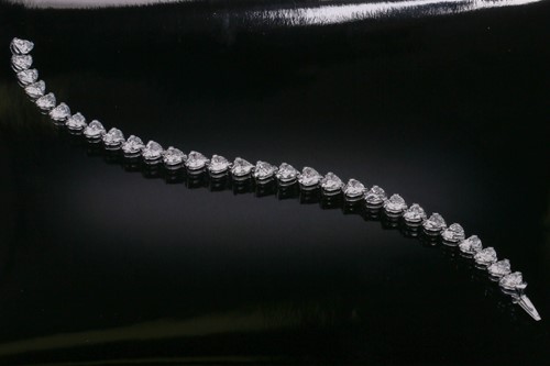 Lot 201 - A diamond tennis bracelet in platinum, set...