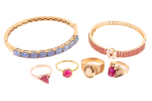 Lot 129 - Four gem-set rings and two gem-set bangles; to...