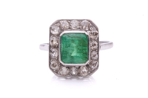 Lot 245 - An emerald and diamond entourage ring,...