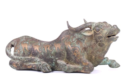 Lot 202 - A Chinese bronze and gilt recumbent bull,...