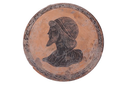 Lot 254 - A Greek style attic pottery portrait roundel,...