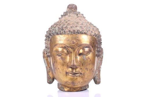 Lot 124 - A Sino-Tibetan gilt bronze head of a Buddha,...