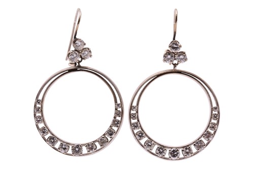 Lot 116 - A pair of diamond hoop earrings, each earring...