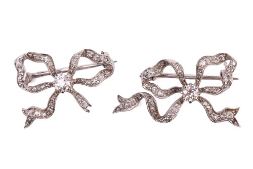 Lot 6 - A pair of diamond bow brooches, each set with...