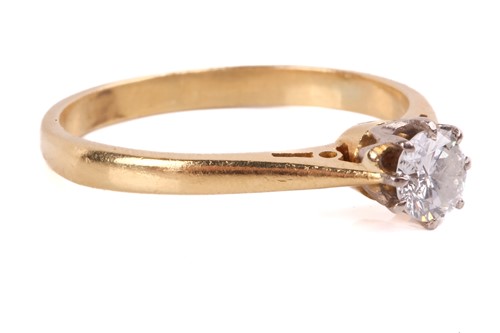 Lot 144 - A diamond solitaire ring set with a round...